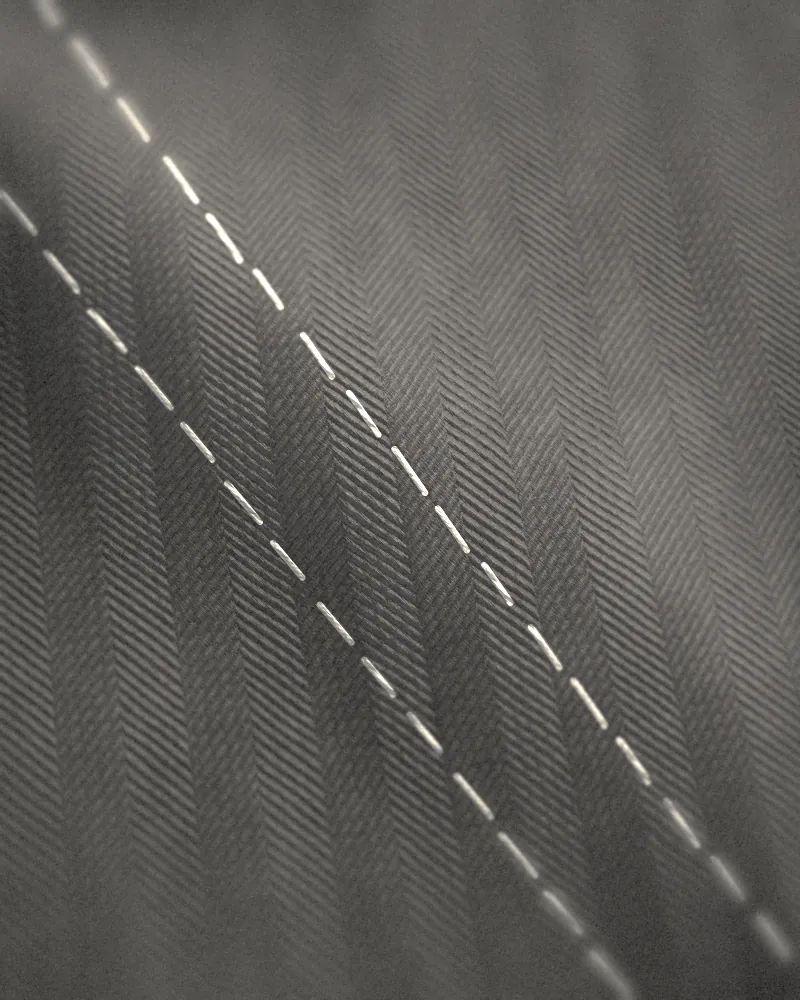 Long white basting stitches on herringbone cloth