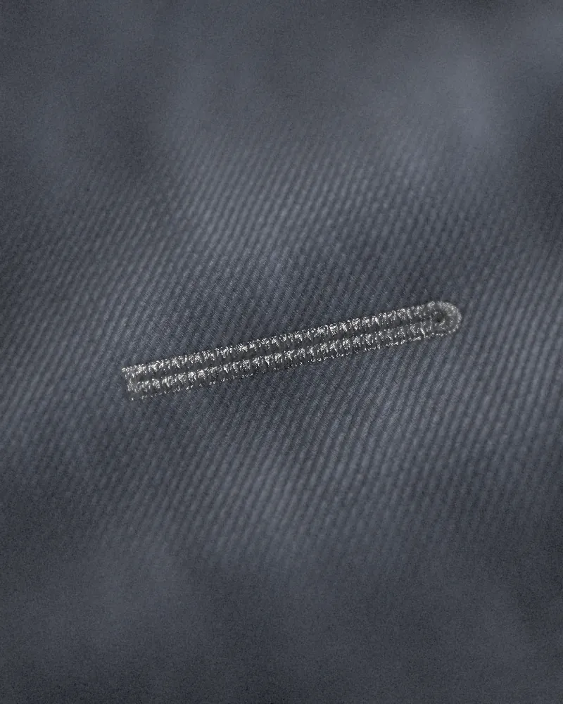 A keyhole buttonhole stitched in silk twist