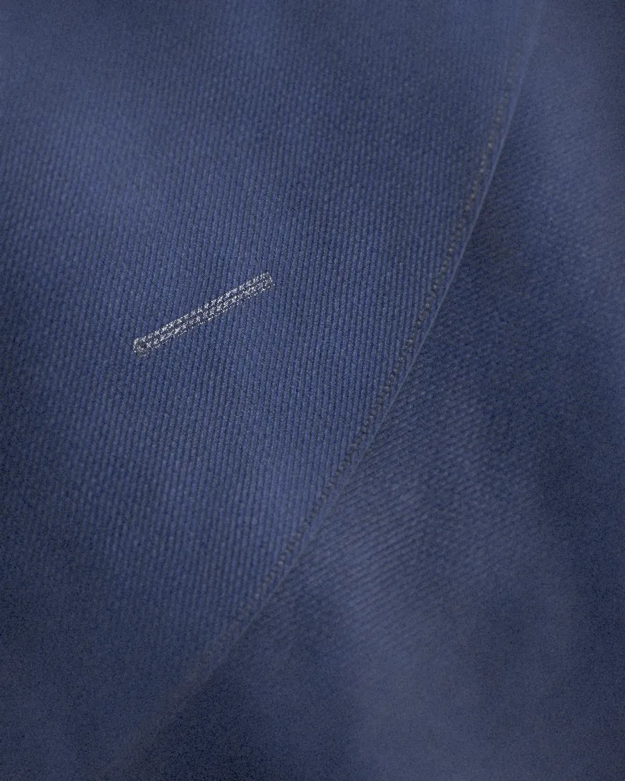 A lapel with pick stitching and a hand-sewn buttonhole